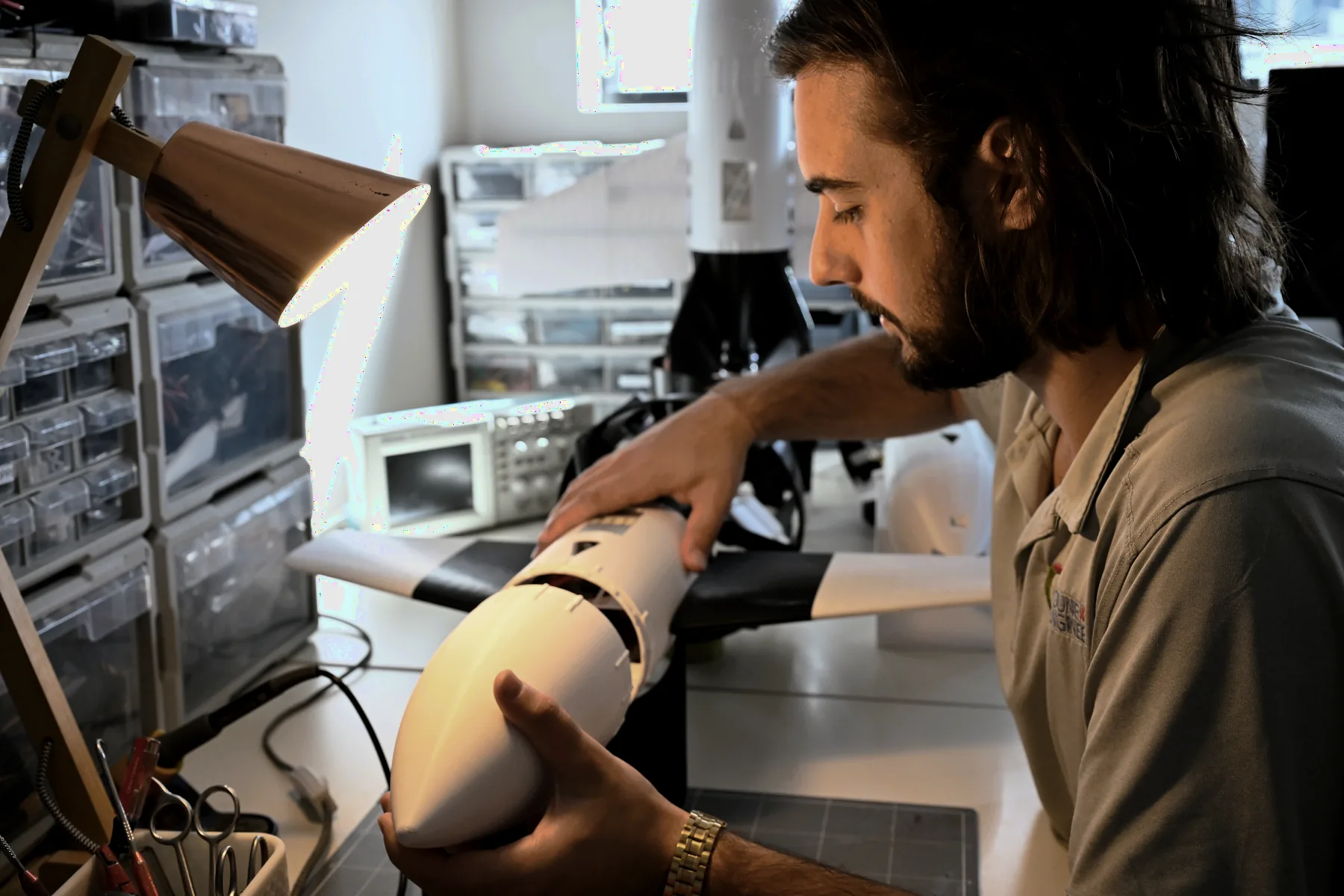 An engineer assembling an aircraft on the build floor